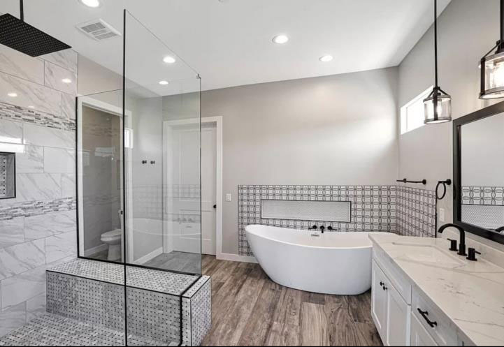 Remodeled bathroom with tile work and wood floors